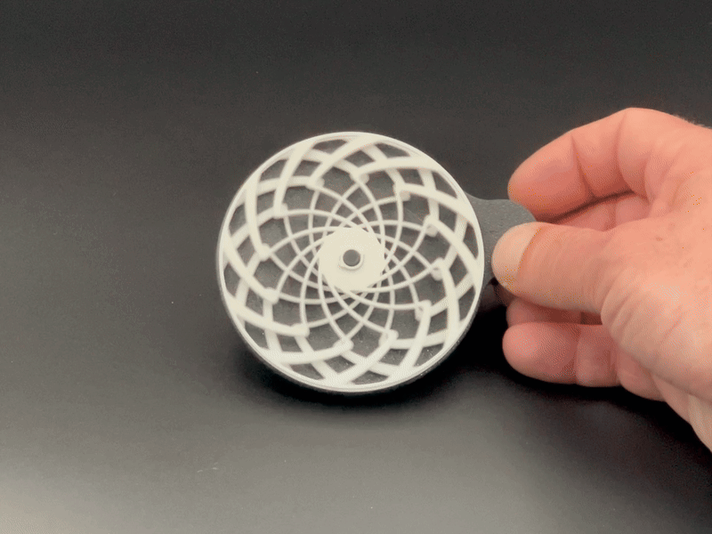 A 3D printed fidget toy moving in a hand